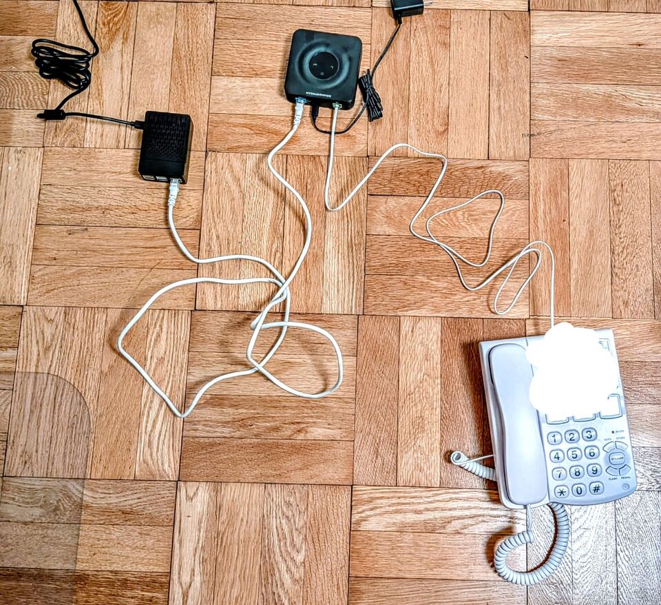 the phone plugged to the HT801 Grandstream plugged to the Raspberry Pi 4B, beaming to the PTSN through twilio